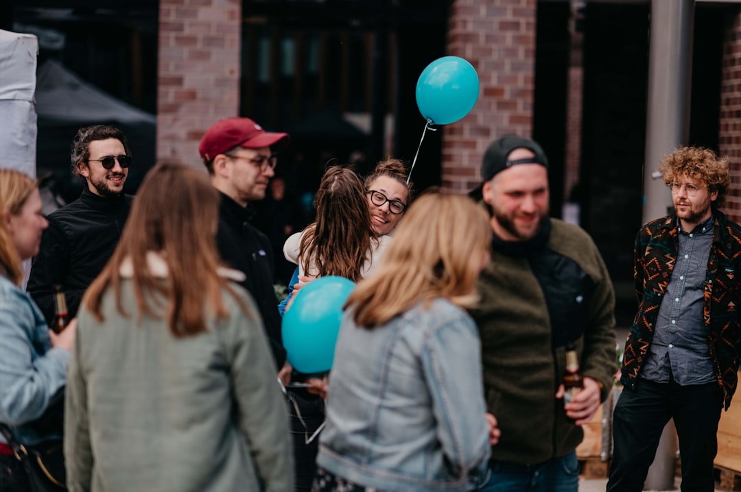 a group of people standing around each other