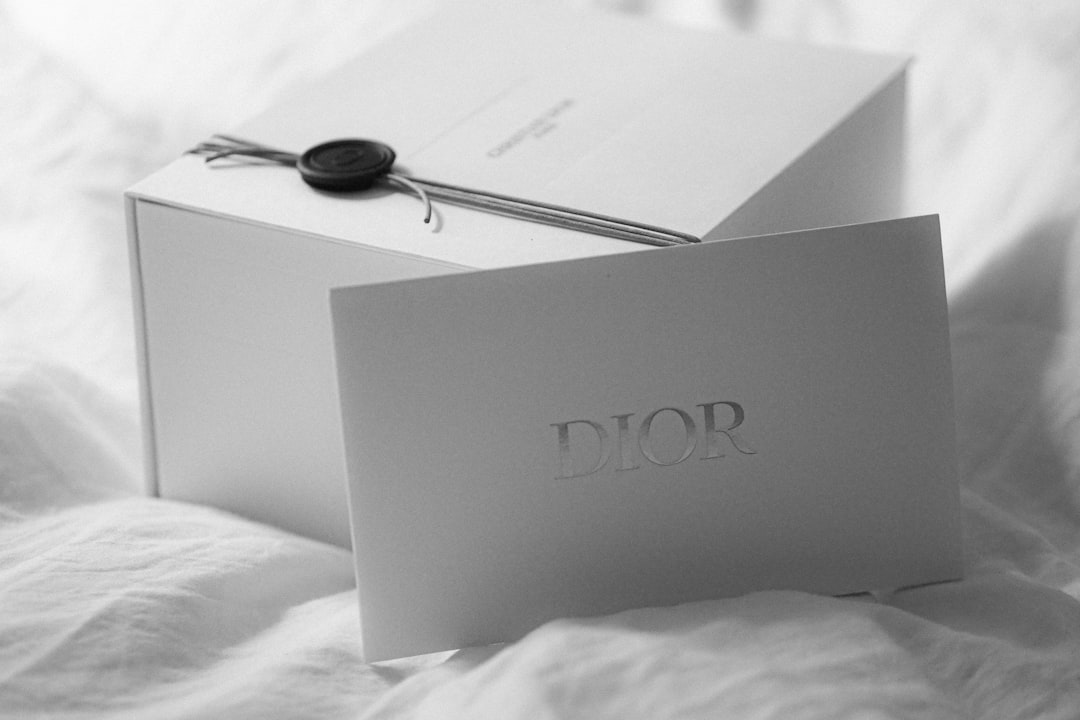 Dior gift box with a card on white fabric