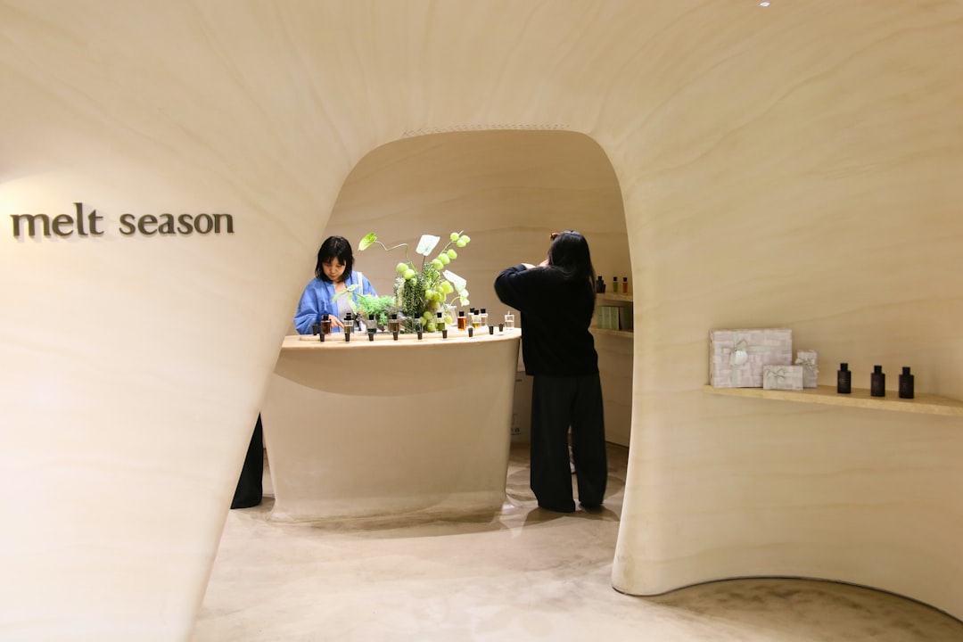 People in a modern store with display shelves.